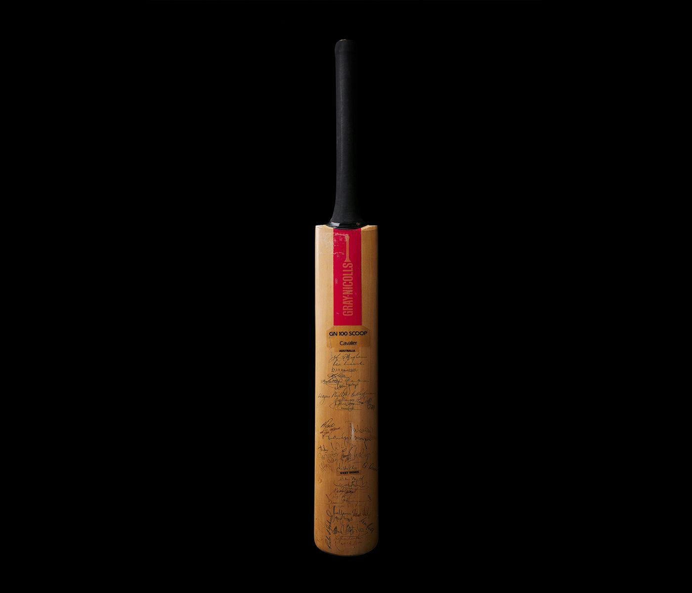A cricket bat, signed by various famous cricket players.
